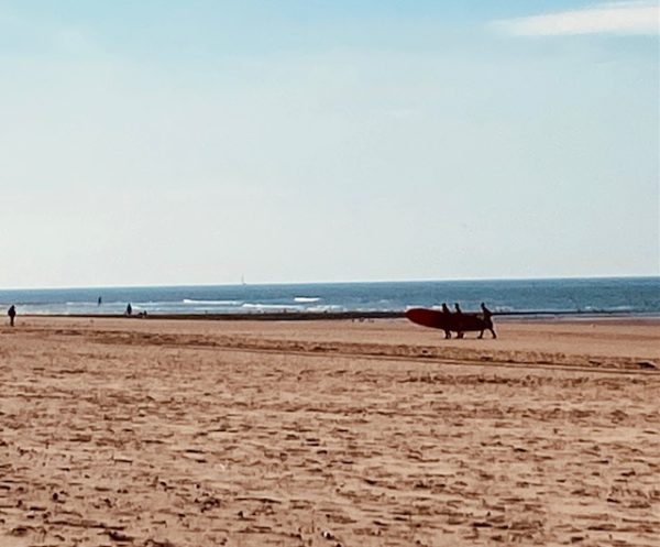 Ostend-SUP-paddle-board-on-beach-2026-9 e persons walking with board after practice